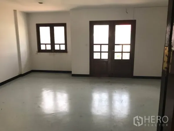 Office Space for rent in Khlong Toei, Bangkok - Spacious office room with wood-framed windows and double glass doors.