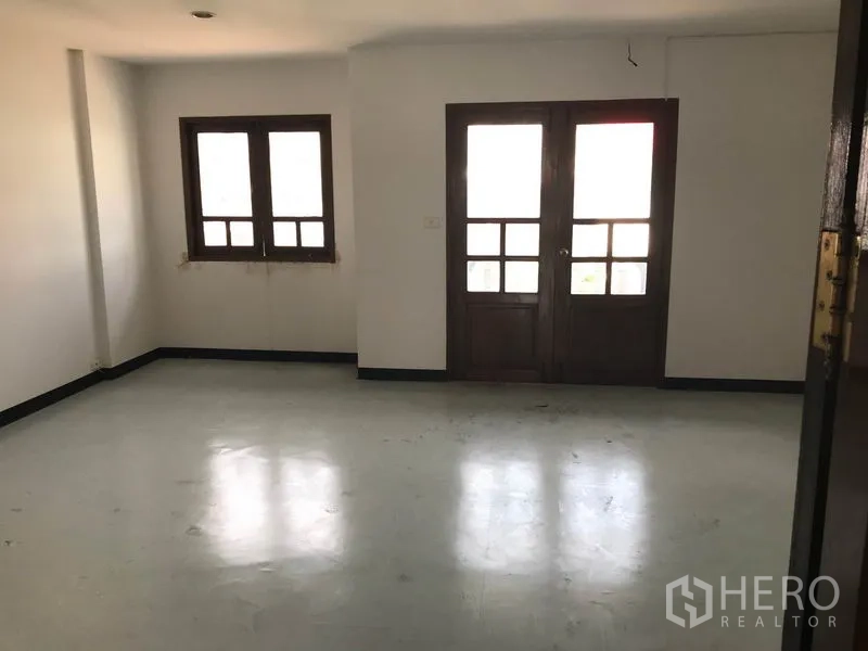 Office Space for rent in Khlong Toei, Bangkok - Spacious office room with wood-framed windows and double glass doors.