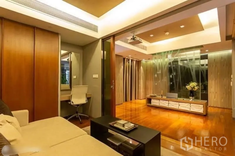 Condominium for rent in Yan Nawa, Bangkok - Warm living zone with recessed lighting, sliding doors, media console and a small study nook.
