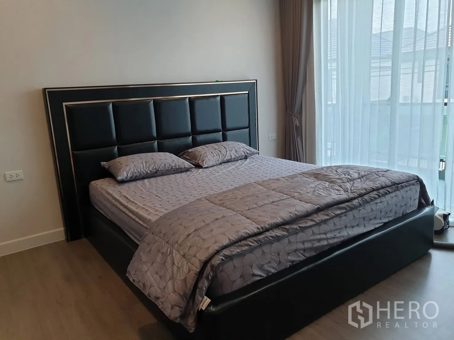 Detached House for rent in Saphan Sung, Bangkok - Bright bedroom with large bed, floor-to-ceiling window and sheer curtains.