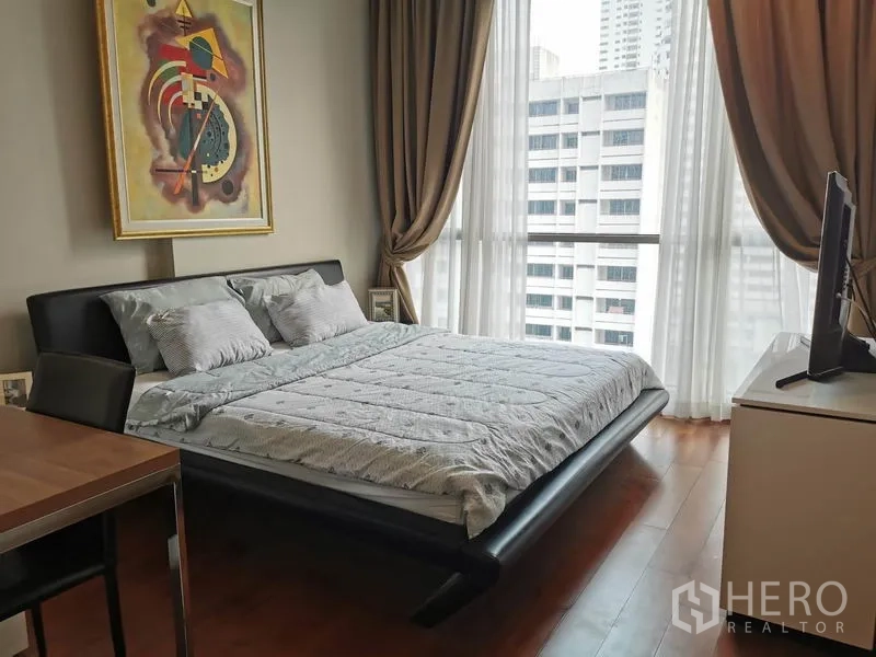 Condominium for rent in Watthana, Bangkok - Primary bedroom with full-height windows, city view and modern bed frame.