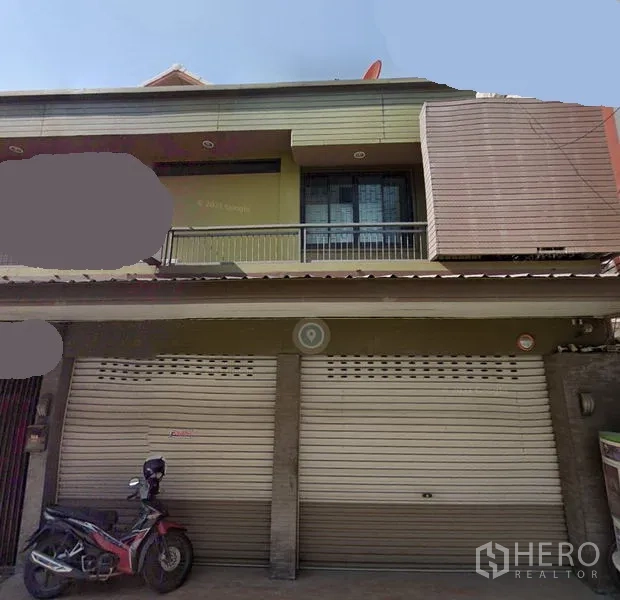 Retail Space for rent in Watthana, Bangkok - Two-storey shophouse-style retail frontage with dual metal roller shutters, balcony and awning in Watthana, Bangkok near BTS On Nut.