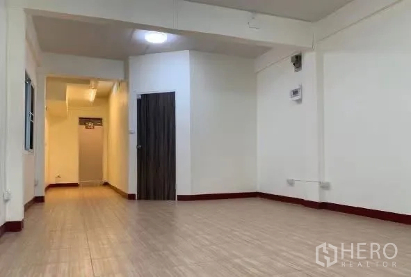 Home Office for rent in Sathon, Bangkok - Open workspace with wood-look floors and windows.