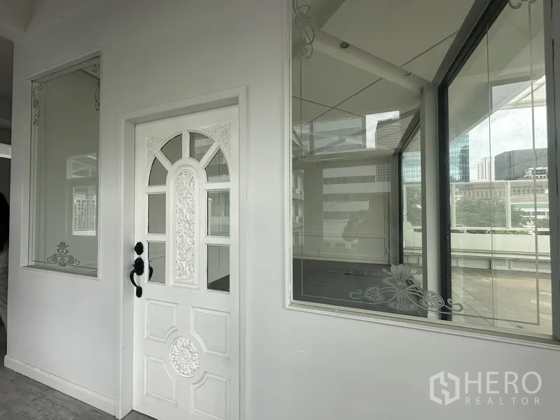 Retail Space for rent in Bang Rak, Bangkok - Close view of ornate white door and picture windows beside terrace.