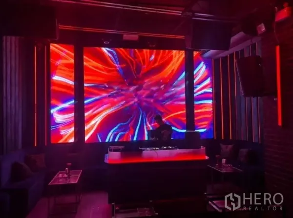 Retail Space for rent in Bangkok - Club-style stage and DJ booth with large LED wall and neon lighting.