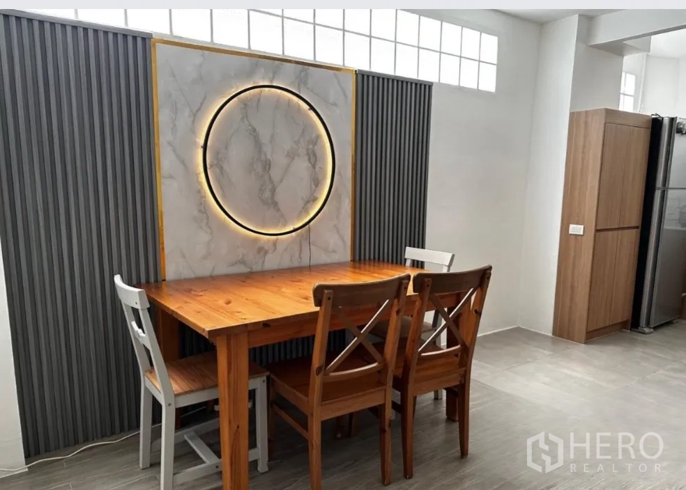 联排别墅 for rent in Sathon, Bangkok - 用餐区设木餐桌、混搭椅子与装饰灯墙。