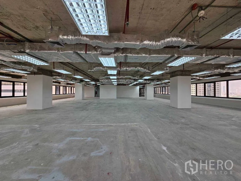 Office Space for rent in Bang Rak, Bangkok - Expansive open-plan workspace with exposed ducting and bright perimeter windows.