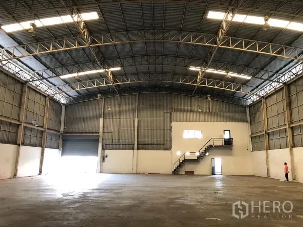 Factory for rent in Wang Noi, Phra Nakhon Si Ayutthaya - Warehouse hall showing roller shutter loading door, concrete floor, and ample clear span.
