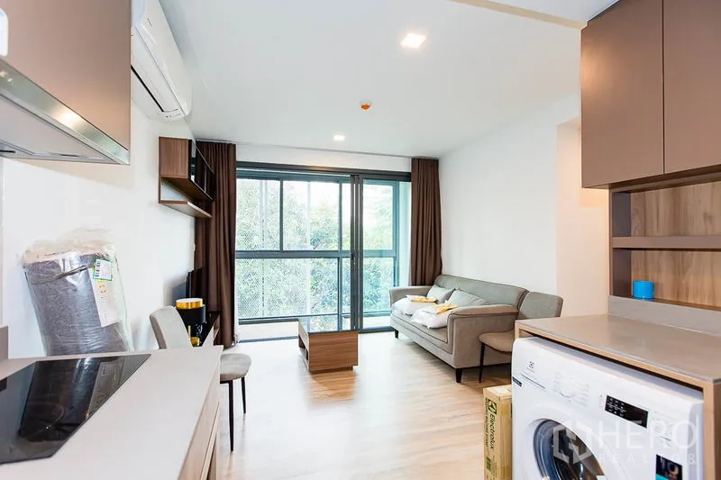 公寓 出租在Watthana, Bangkok - 从厨房望向客厅与大面积推拉玻璃门，室内洗衣机
