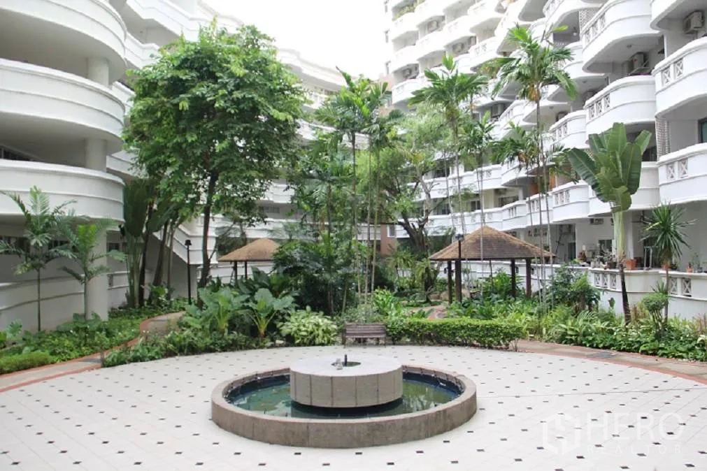 Condominium for sale in Wang Thonglang, Bangkok - Landscaped courtyard with fountain and seating inside the condo complex.