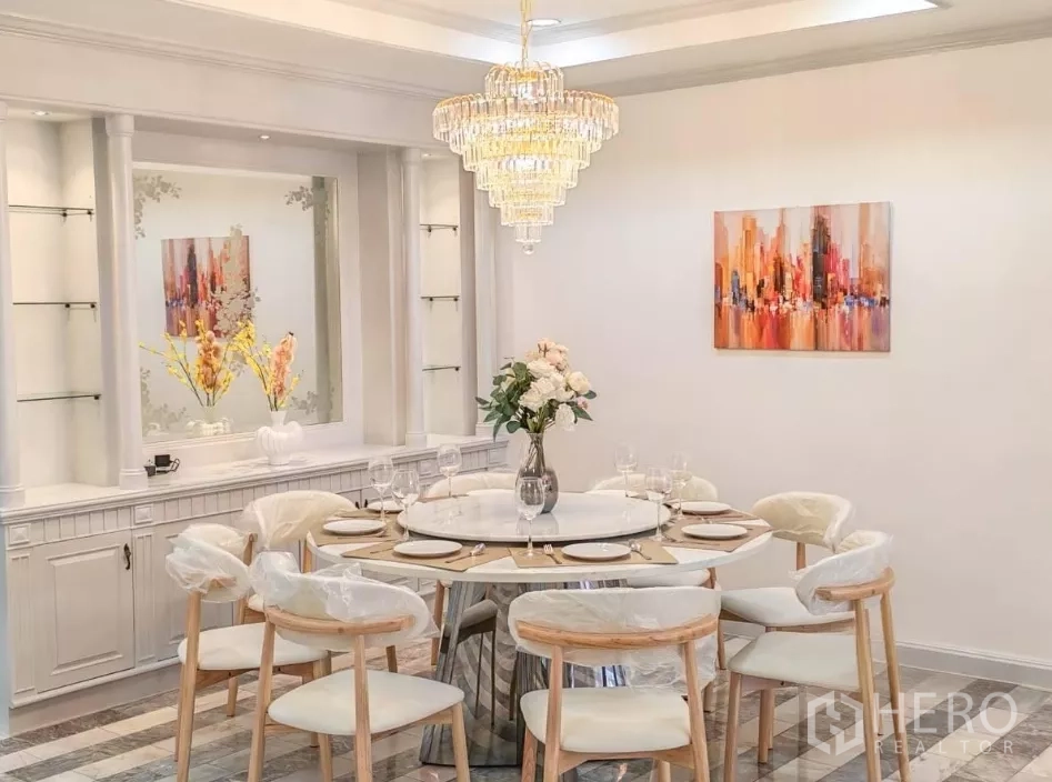 Detached House for rent in Yan Nawa, Bangkok - Formal dining room with a crystal chandelier and a round table set for a meal.