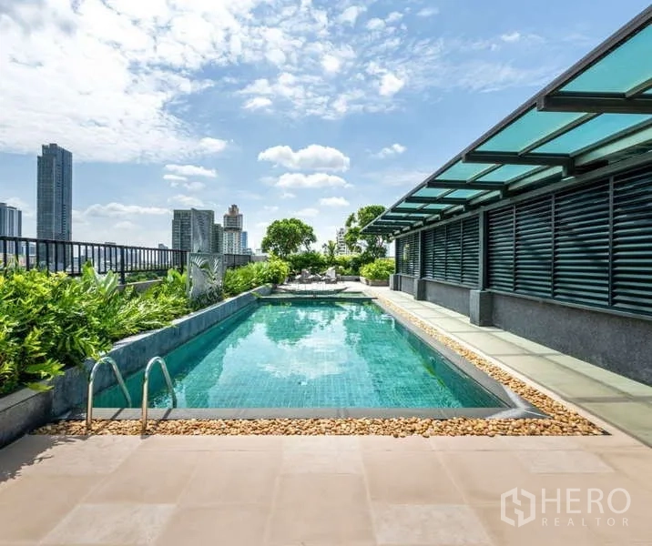 Condominium for rent - Rooftop swimming pool with city skyline views and sun deck seating.