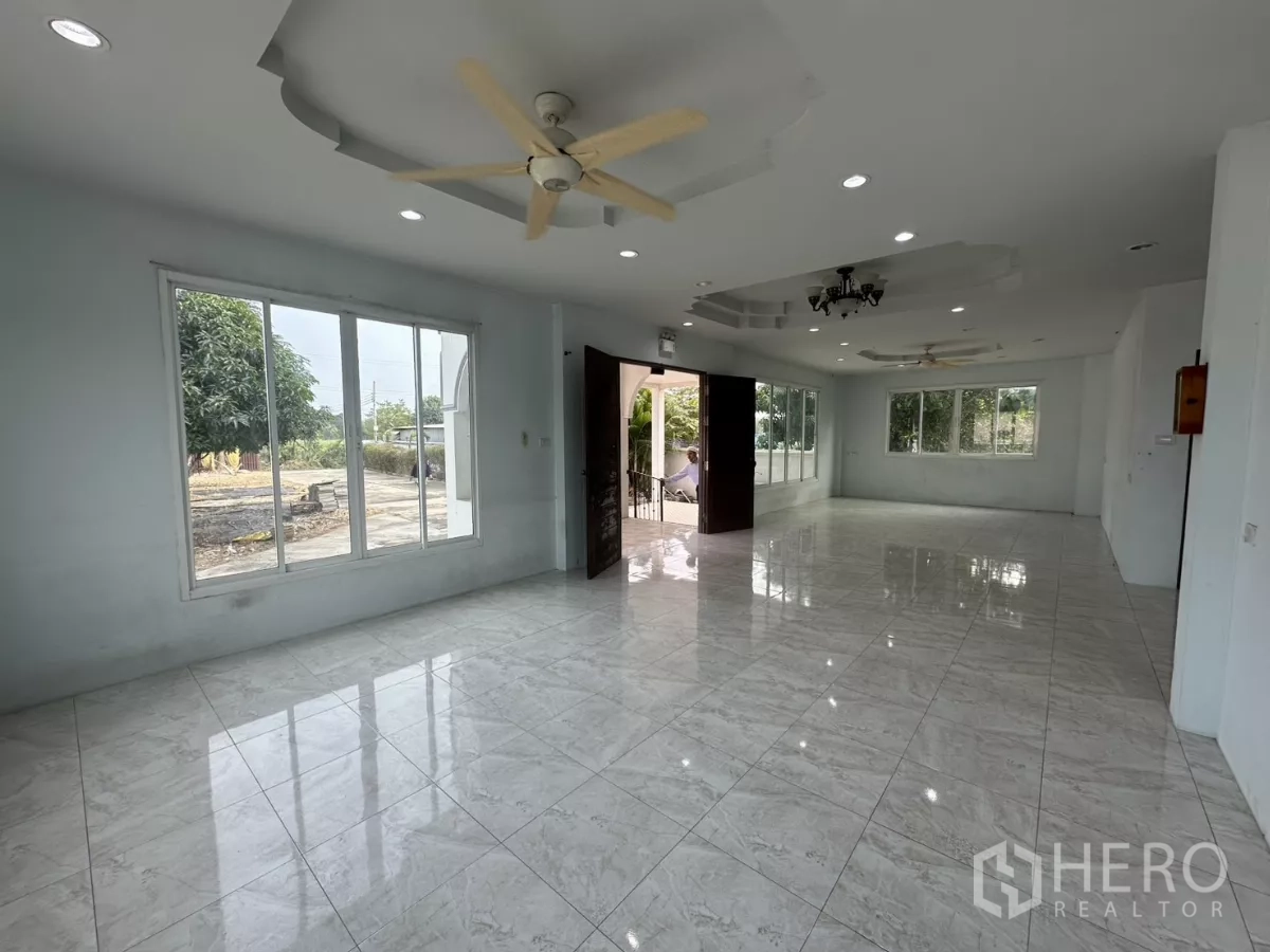 Home Office for rent - Large open-plan hall with glossy tile flooring, ceiling fans and picture windows.