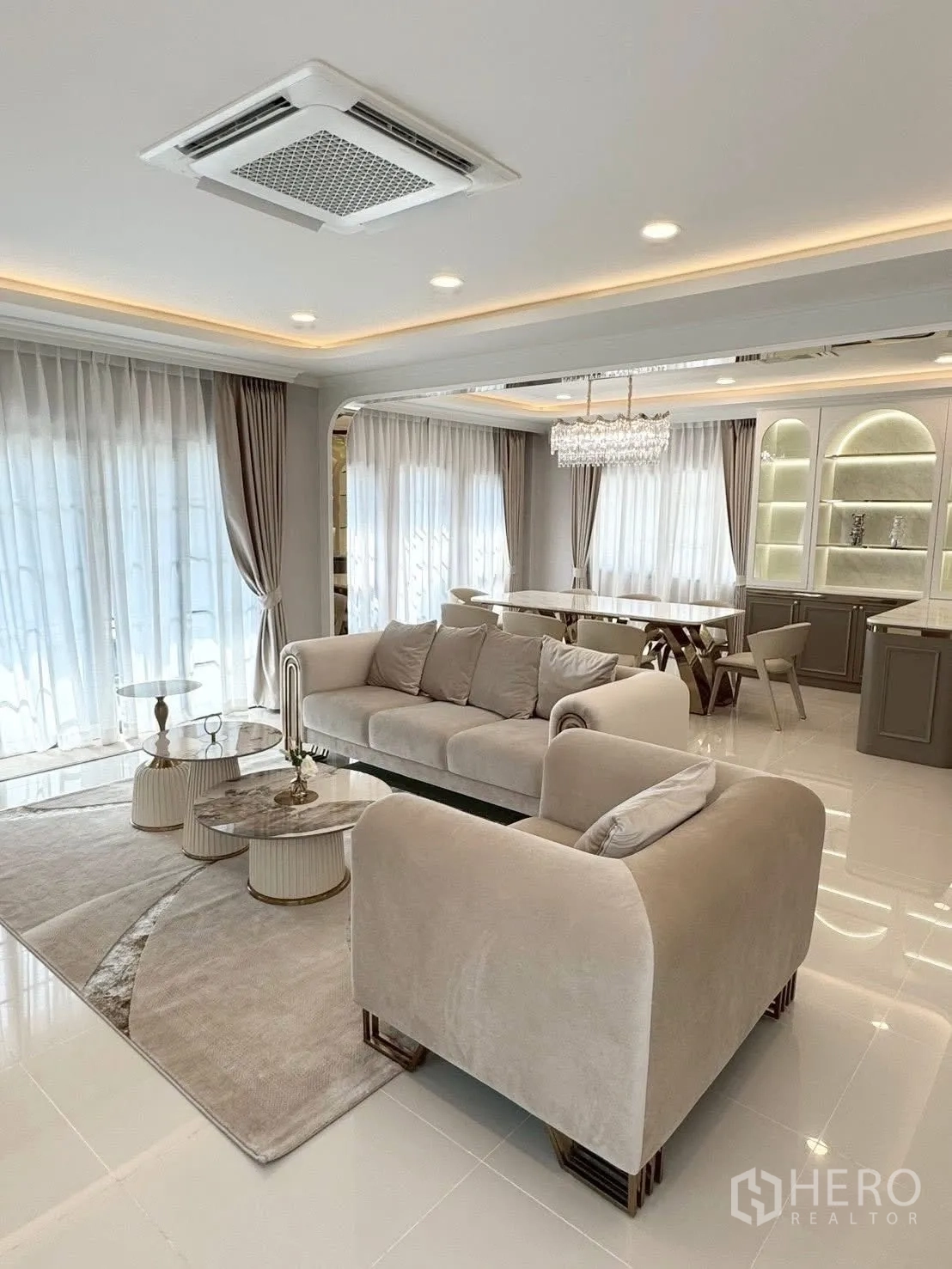 独立式住宅 出租在Bang Phli, Samut Prakan - 开放式客餐厅，大窗与嵌入式天花空调，中性色调。