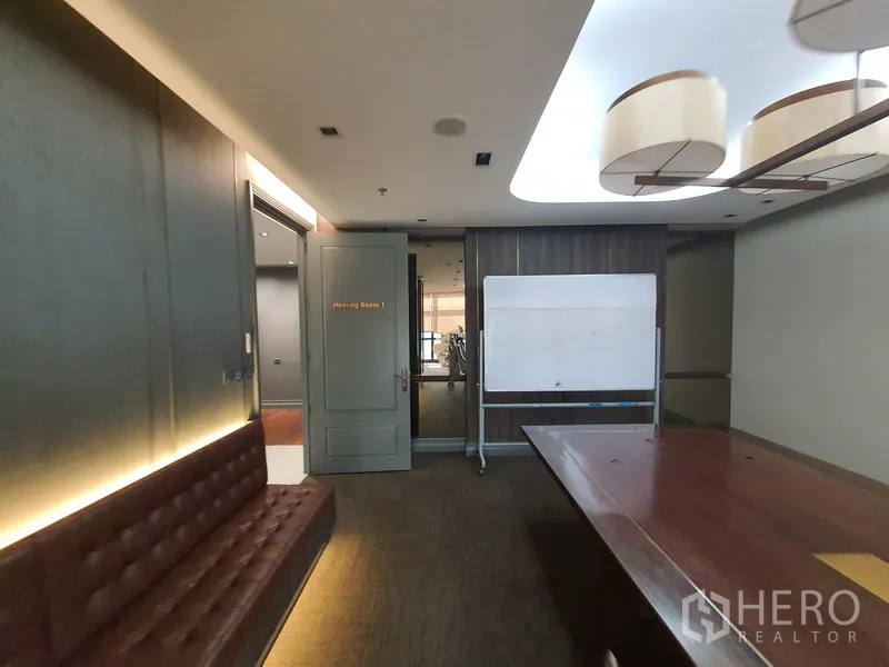 Office Space for rent in Khlong Toei, Bangkok - Meeting room with wooden table, bench seating and mobile whiteboard.