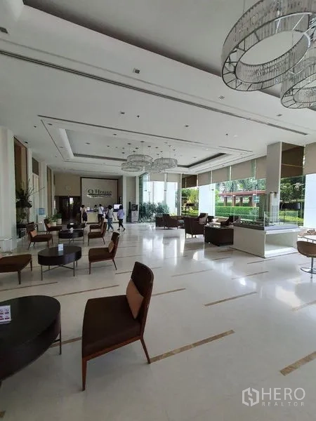 Condominium for sale - Elegant high-ceiling lobby lounge with seating areas and floor-to-ceiling windows.