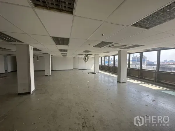 Office Space for rent in Khlong Toei, Bangkok - Corner office area with a long row of windows delivering city views and abundant natural light.