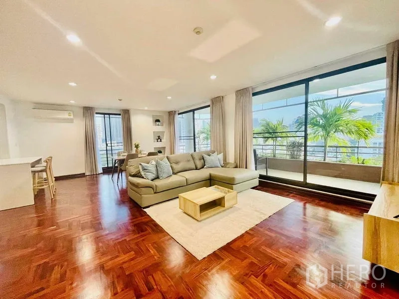 Condominium for rent - Light-filled living room with sliding doors opening to the balcony.
