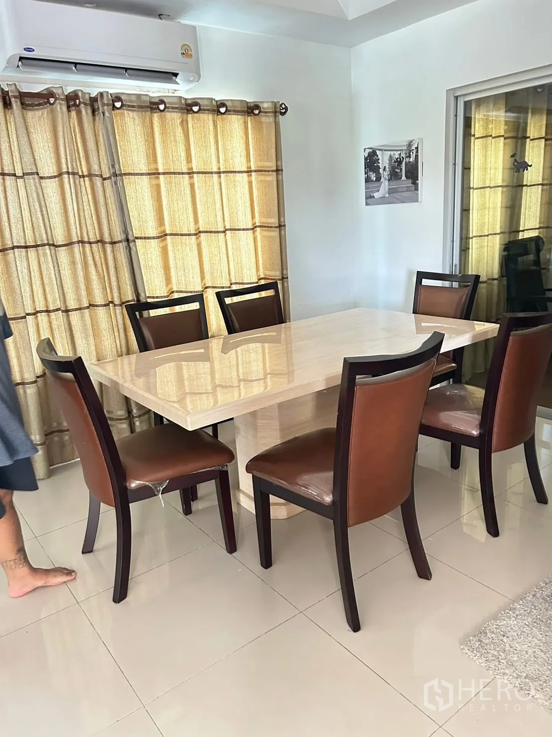 Detached House for rent in Bang Na, Bangkok - Formal dining room with six chairs, marble-top table, and air conditioner.