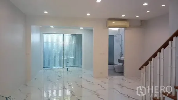 Townhouse for rent in Yan Nawa, Bangkok - Bright lounge with ceiling spotlights and floor‑to‑ceiling sliding doors.
