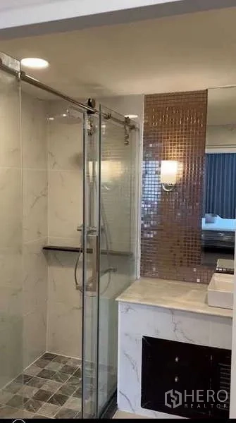 Condominium for rent or sale in Khlong Toei, Bangkok - Modern bathroom with glass shower, mosaic accent tile and marble vanity