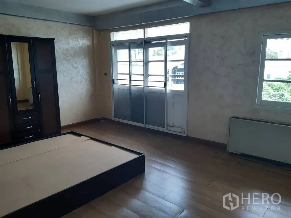 联排别墅 出租在Khlong Toei, Bangkok - 卧室通向阳台的推拉门一侧，仿木地板。