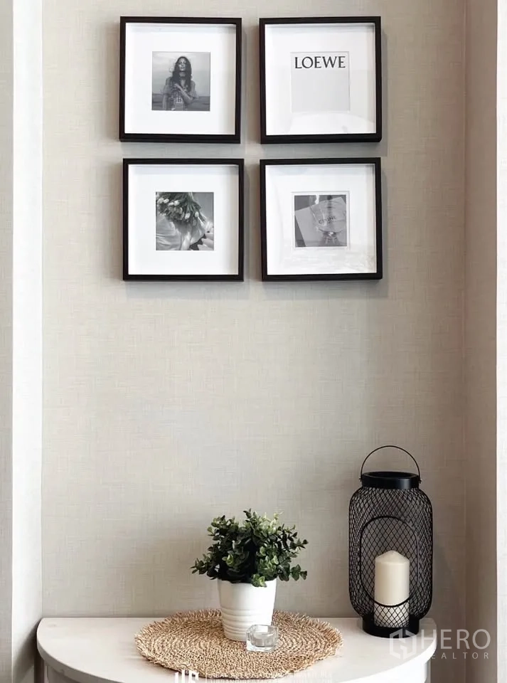 Condominium for rent in Watthana, Bangkok - Decor nook with framed wall art, potted plant and candle lantern on a console table.