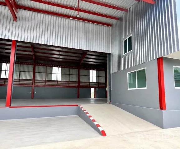Warehouse for rent in Bang Bo, Samut Prakan - Covered loading dock with drive-in ramp leading into the warehouse interior.