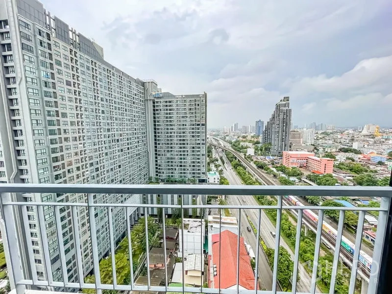 Condominium for sale - High-floor balcony view of neighboring towers, BTS tracks and cityscape.