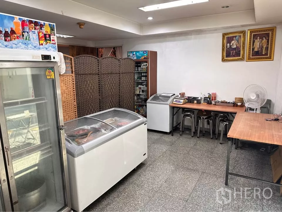 Retail Space for rent in Watthana, Bangkok - Storage and utility room with display freezers, refrigerator, and work tables.
