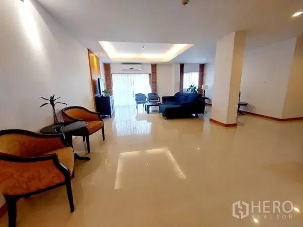 Apartment for rent - Spacious living hall with multiple seating zones, glossy floors and natural light.