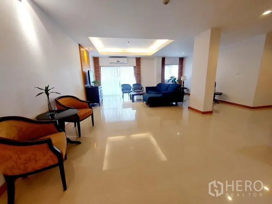 Apartment for rent - Spacious living hall with multiple seating zones, glossy floors and natural light.