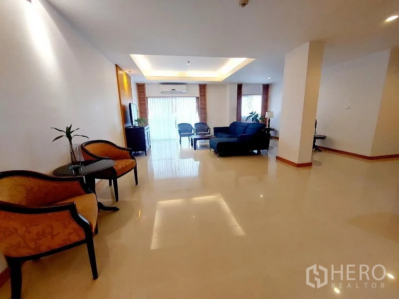 Apartment for rent - Spacious living hall with multiple seating zones, glossy floors and natural light.