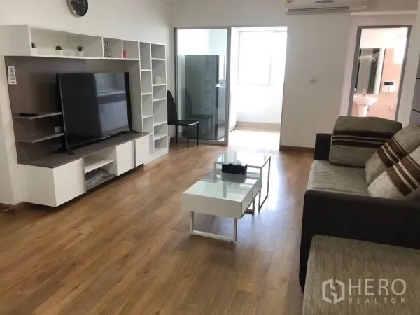 คอนโด ให้เช่าในHuai Khwang, Bangkok - ห้องนั่งเล่นพร้อมชั้นวางทีวีและชั้นโชว์ ประตูกระจกบานเลื่อนไปยังโซนซักล้าง และทางเข้าห้องน้ำ