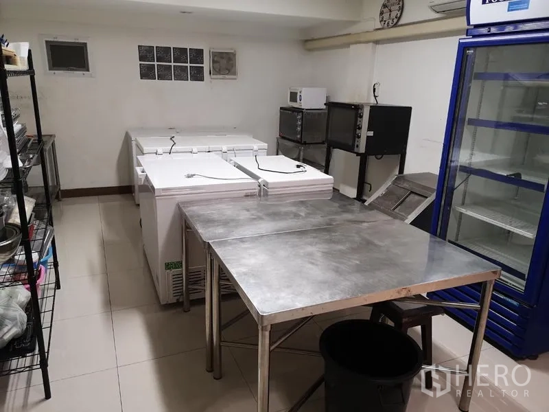 Retail Space for rent in Khlong Toei, Bangkok - Commercial kitchen zone with freezers, worktables, ovens and upright fridge.
