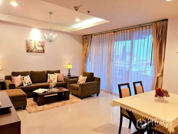 Apartment for rent - Bright open-plan living and dining area with sofa set, chandelier and floor-to-ceiling curtains.