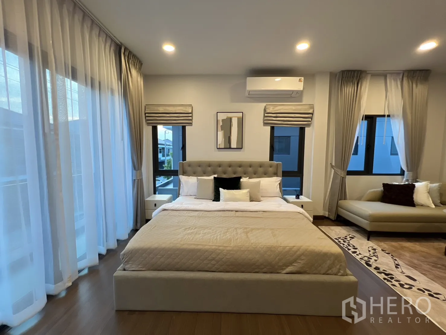 Detached House for rent in Bang Phli, Samut Prakan - Master bedroom with large bed, sheer curtains and balcony-facing windows.