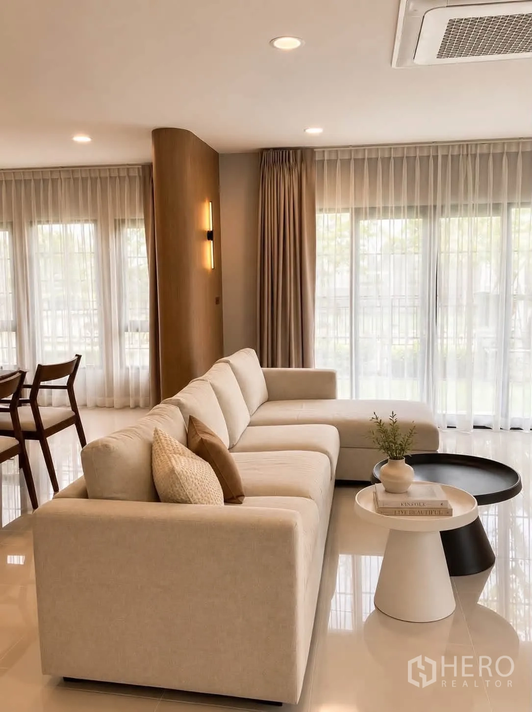 Detached House for rent in Bang Phli, Samut Prakan - Lounge with an L-shaped sofa beside floor-to-ceiling windows and sheer drapes.