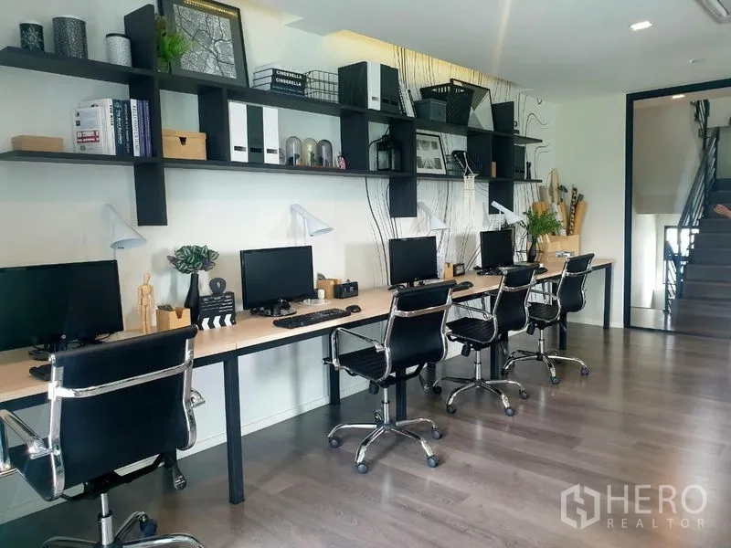 Home Office for rent - Open‑plan workspace with long bench desks, monitors and swivel chairs.