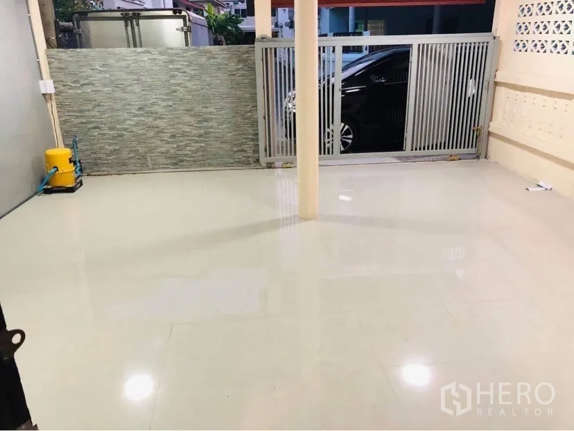 联排别墅 出租或出售在Huai Khwang, Bangkok - 有顶车位，瓷砖地面，推拉大门与石材装饰墙。