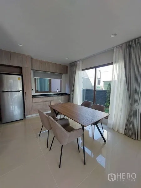 Detached House for rent in Bang Kapi, Bangkok - Modern two-storey detached house exterior with gated carport and small garden.