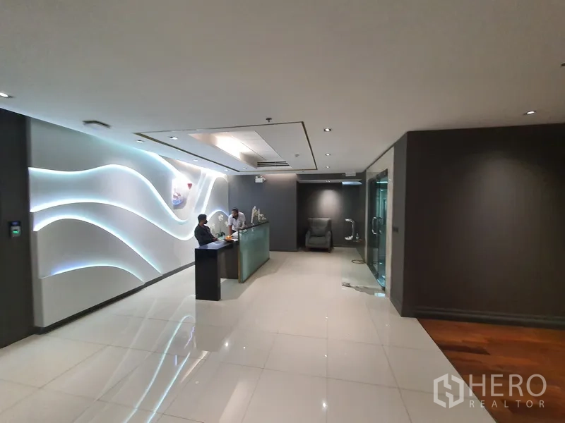 Office Space for rent in Khlong Toei, Bangkok - Spacious reception area with glass entry and illuminated wall panels.