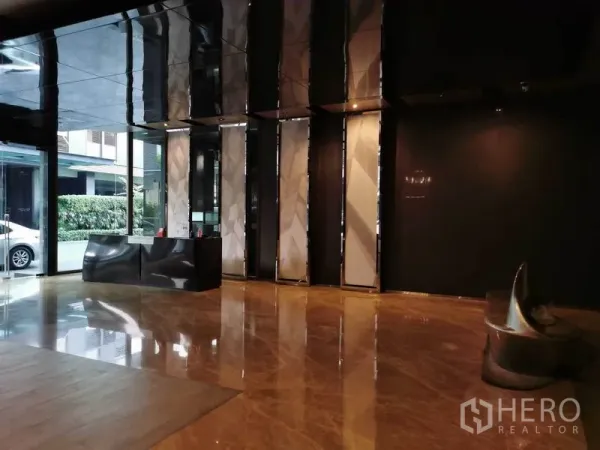 Condominium for rent in Watthana, Bangkok - Elegant condo lobby with marble floors, high ceilings and a reception desk.