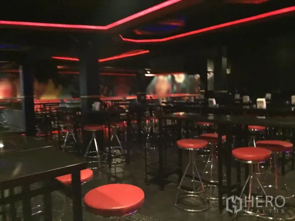 Retail Space for rent in Watthana, Bangkok - Spacious bar area with high tables, chrome stools and red ceiling lighting.