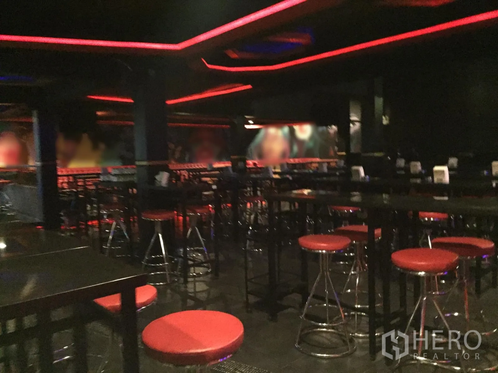 Retail Space for rent in Watthana, Bangkok - Spacious bar area with high tables, chrome stools and red ceiling lighting.