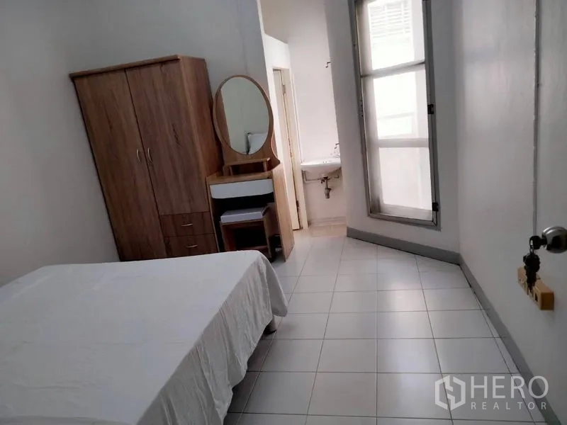 Shophouse for rent - Long bedroom with wardrobe, large window and an ensuite sink area.