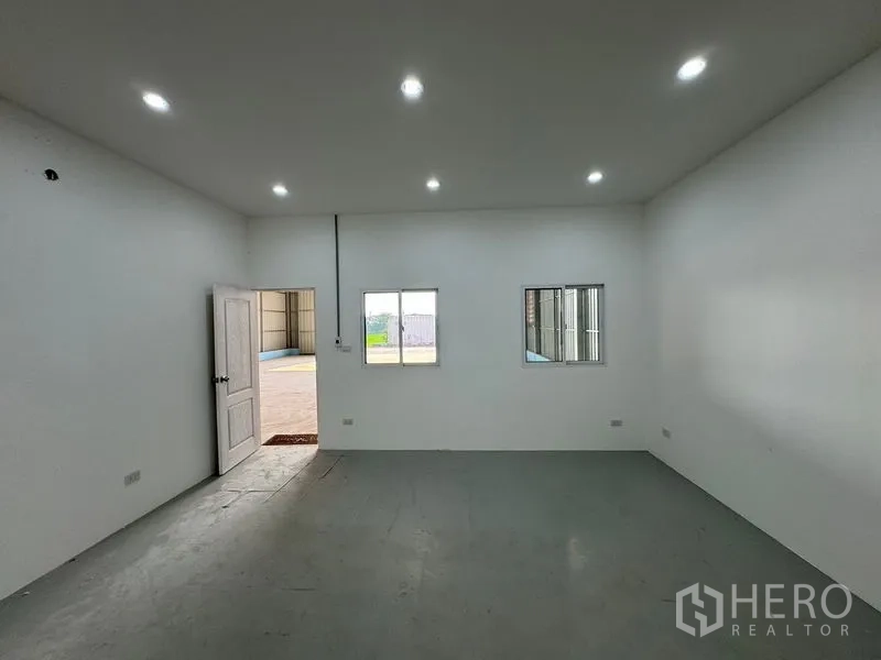 Warehouse for rent in Lam Luk Ka, Pathum Thani - White office room inside the warehouse with windows, door and LED downlights.