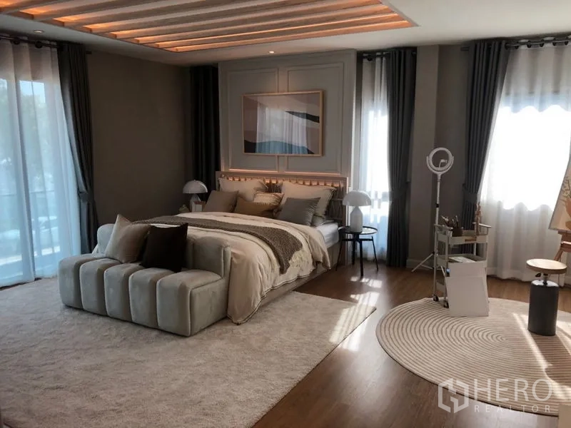 Detached House for sale - Spacious master bedroom with king bed, cove-lit ceiling, wide windows, soft rugs and wood flooring.