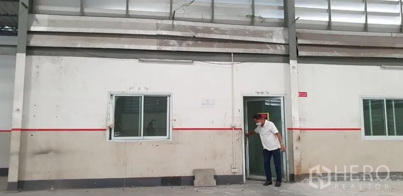 Warehouse for rent in Lam Luk Ka, Pathum Thani - Close-up of an interior access door and sliding windows beneath clerestory vents.