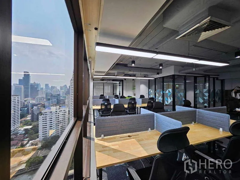 Office Space for rent in Ratchathewi, Bangkok - Workstations beside large windows with skyline view, exposed ceiling and glass meeting rooms.